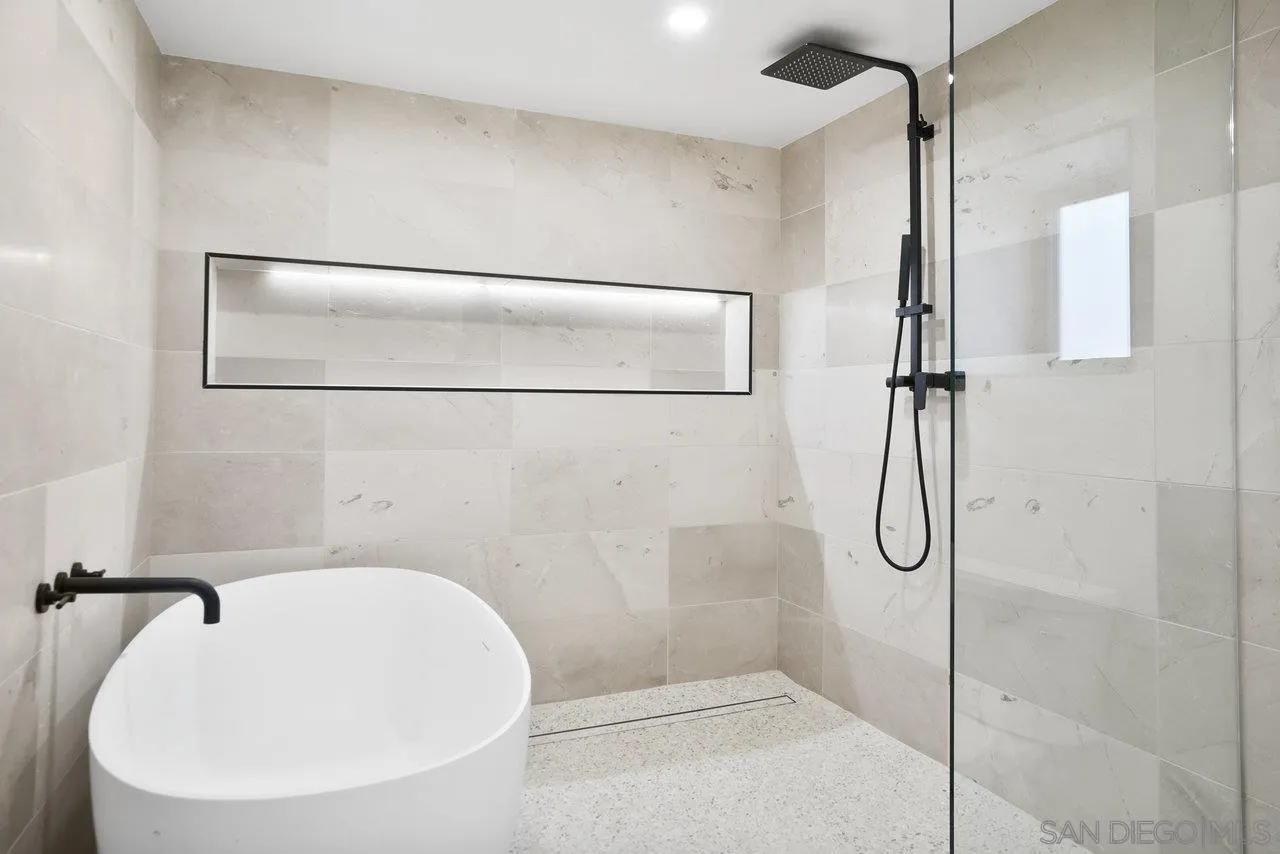 8843 Mariposa Street La Mesa, CA 91941 - Photo 37 of 60 a bathroom with a white bath tub and shower