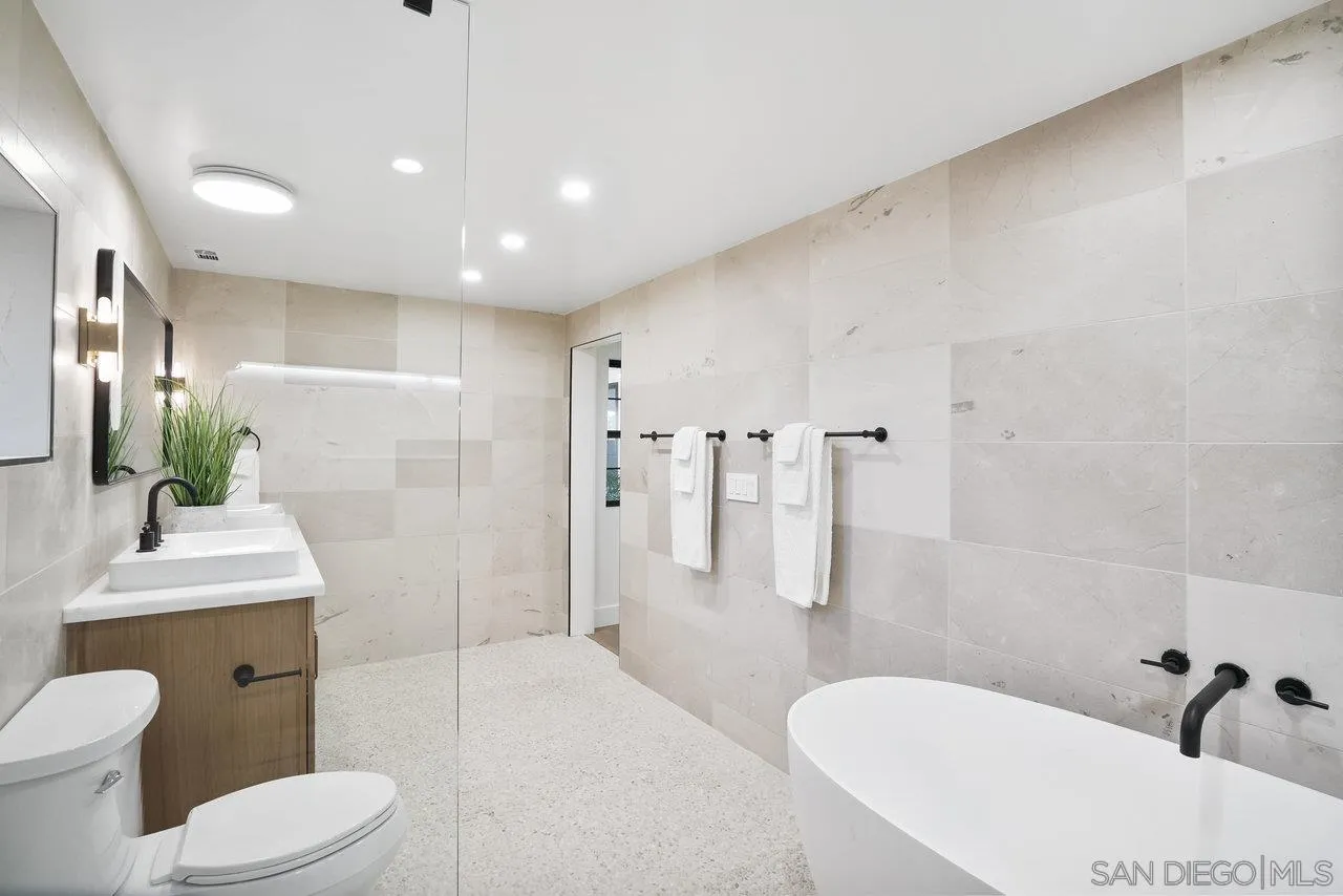 8843 Mariposa Street La Mesa, CA 91941 - Photo 38 of 60 a bathroom with a toilet sink and shower