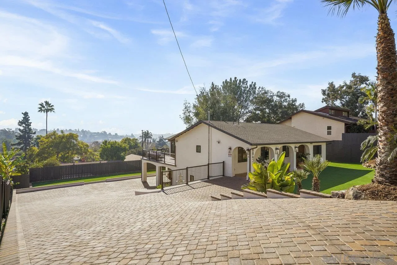 8843 Mariposa Street La Mesa, CA 91941 - Photo 50 of 60 a view of a house with a yard and large trees
