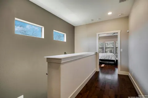 a view of hallway with wooden floor