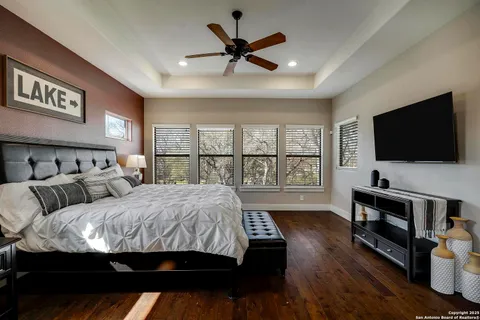 a bedroom with a bed window and a flat screen television