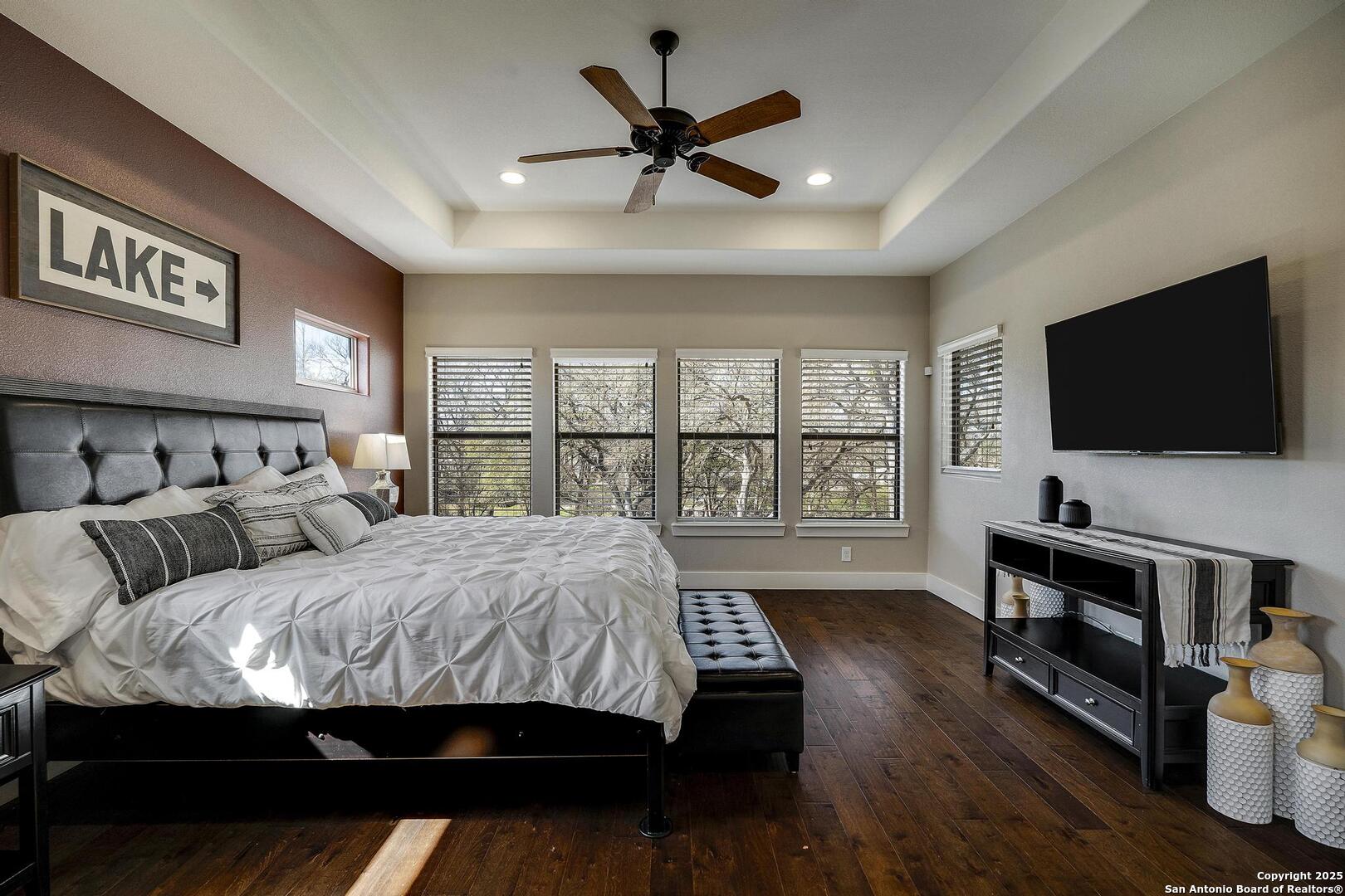 630 3 Oaks Road Seguin, TX 78155 - Photo 16 of 36 a bedroom with a bed window and a flat screen television