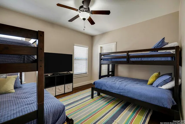 a bedroom with furniture and a flat screen tv