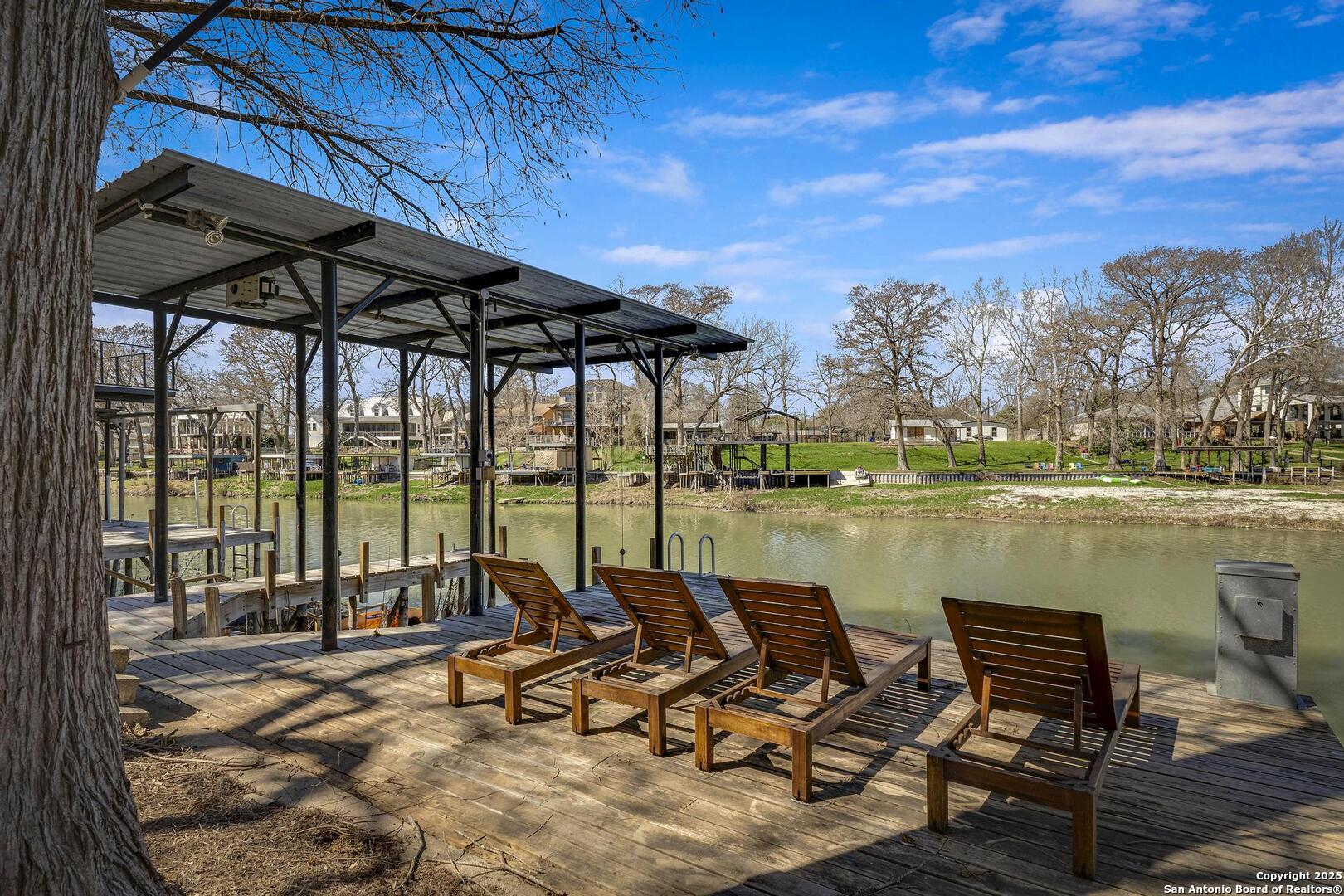 630 3 Oaks Road Seguin, TX 78155 - Photo 32 of 36 a view of a lake with couches and city view