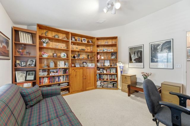 a bedroom with furniture and a book shelf