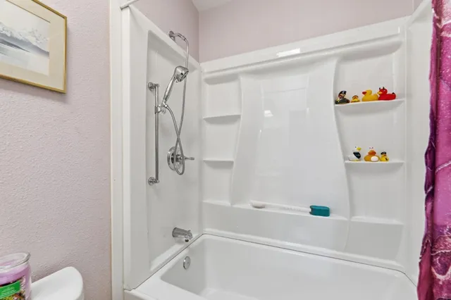 a bathroom with a bathtub and a shower