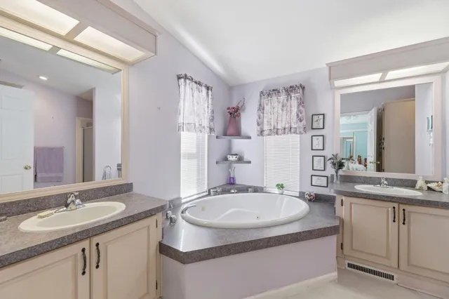 a bathroom with a sink double vanity granite and a mirror