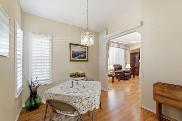 a view of a a dining room with furniture window and wooden floor