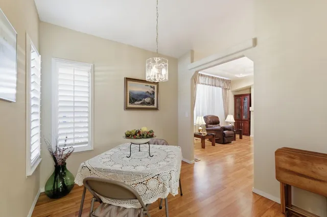 a view of a a dining room with furniture window and wooden floor
