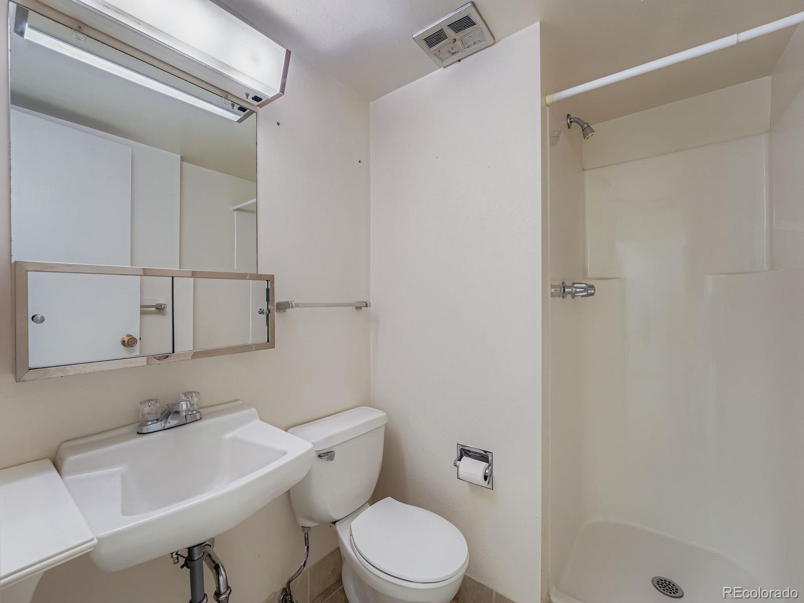 3447 South Norfolk Way Aurora, CO 80013 - Photo 5 of 14 a bathroom with a sink toilet and shower