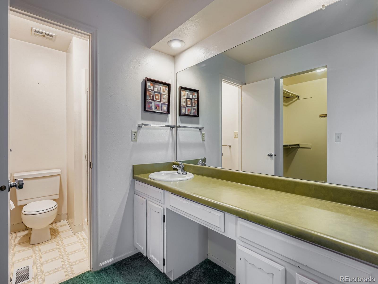 3447 South Norfolk Way Aurora, CO 80013 - Photo 6 of 14 a bathroom with a granite countertop sink and a mirror