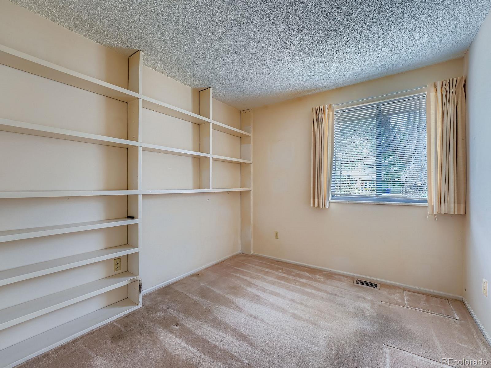 3447 South Norfolk Way Aurora, CO 80013 - Photo 9 of 14 a view of an empty room with a window