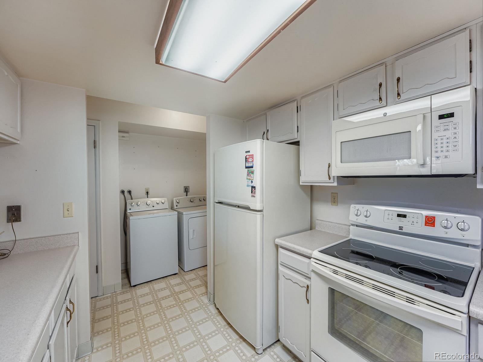 3447 South Norfolk Way Aurora, CO 80013 - Photo 10 of 14 a kitchen with a stove and a refrigerator
