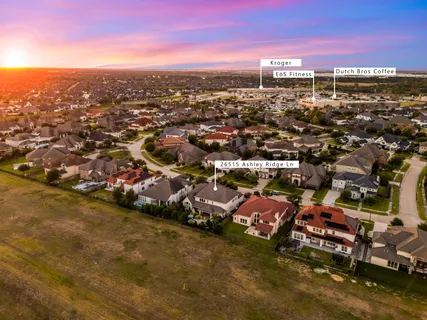 an aerial view of residential houses with city view