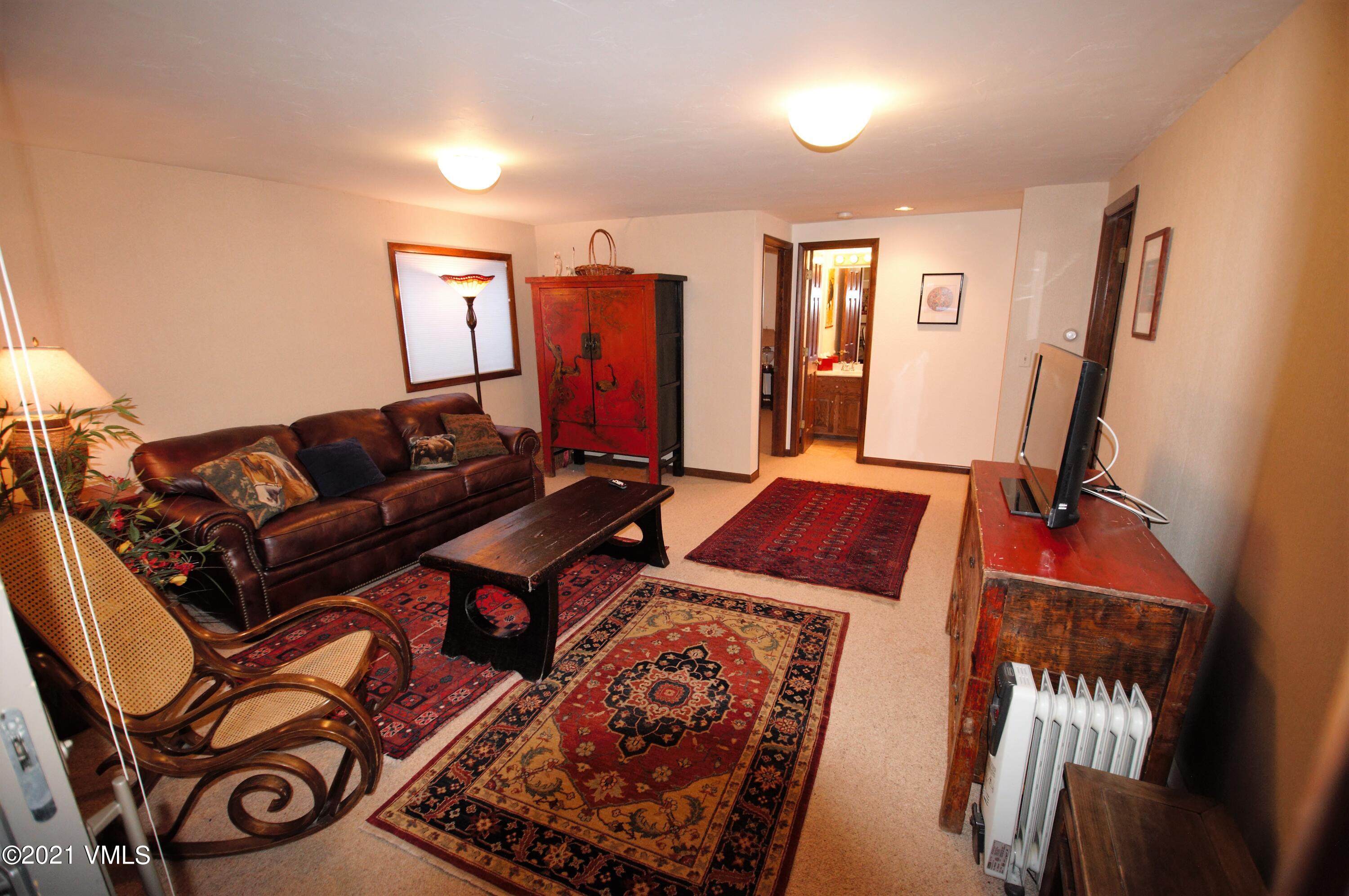 4484 Streamside Circle Vail, CO 81657 - Photo 12 of 29 a living room with furniture and a flat screen tv