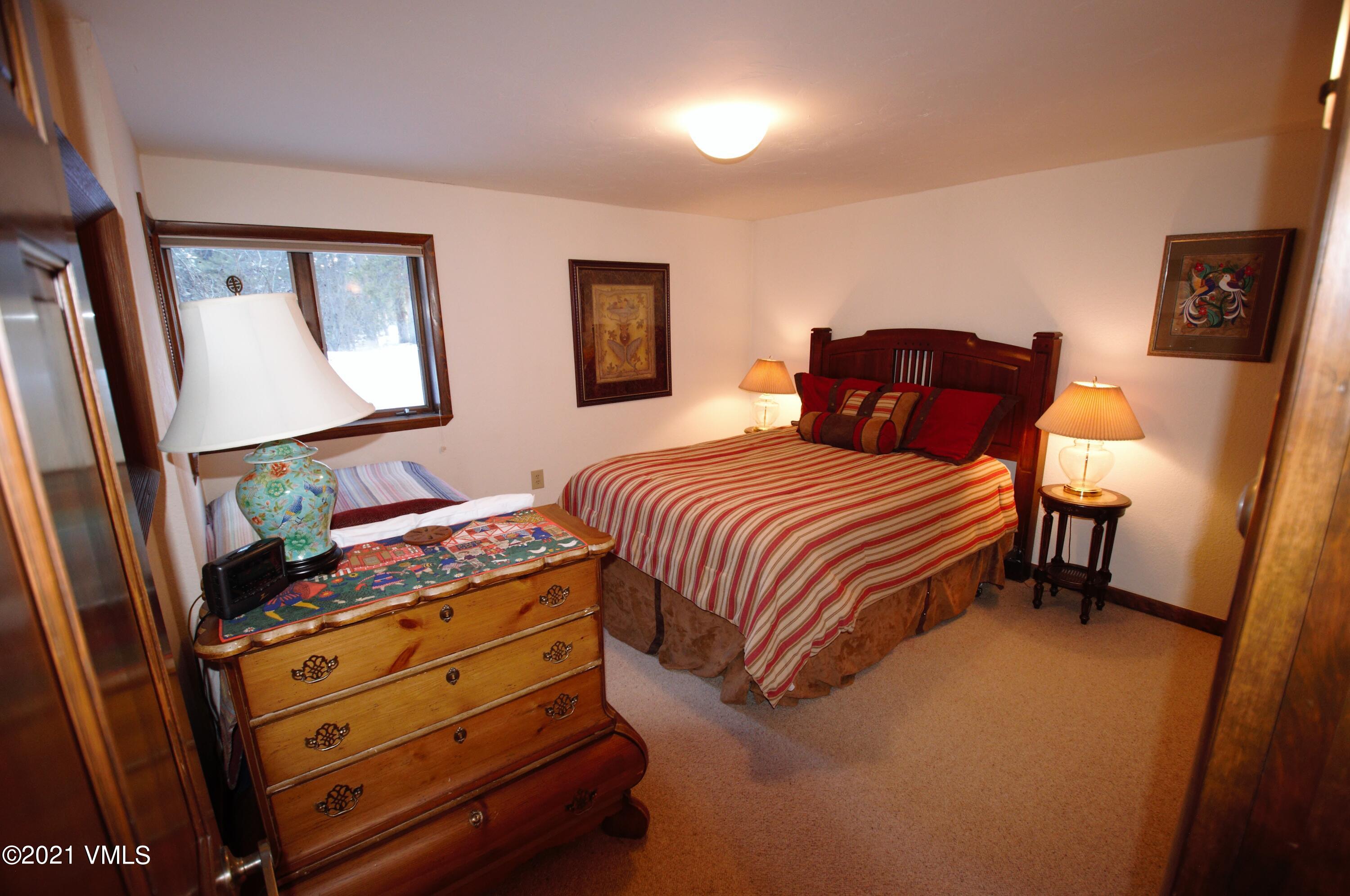 4484 Streamside Circle Vail, CO 81657 - Photo 13 of 29 a bedroom with a bed and a dresser in it