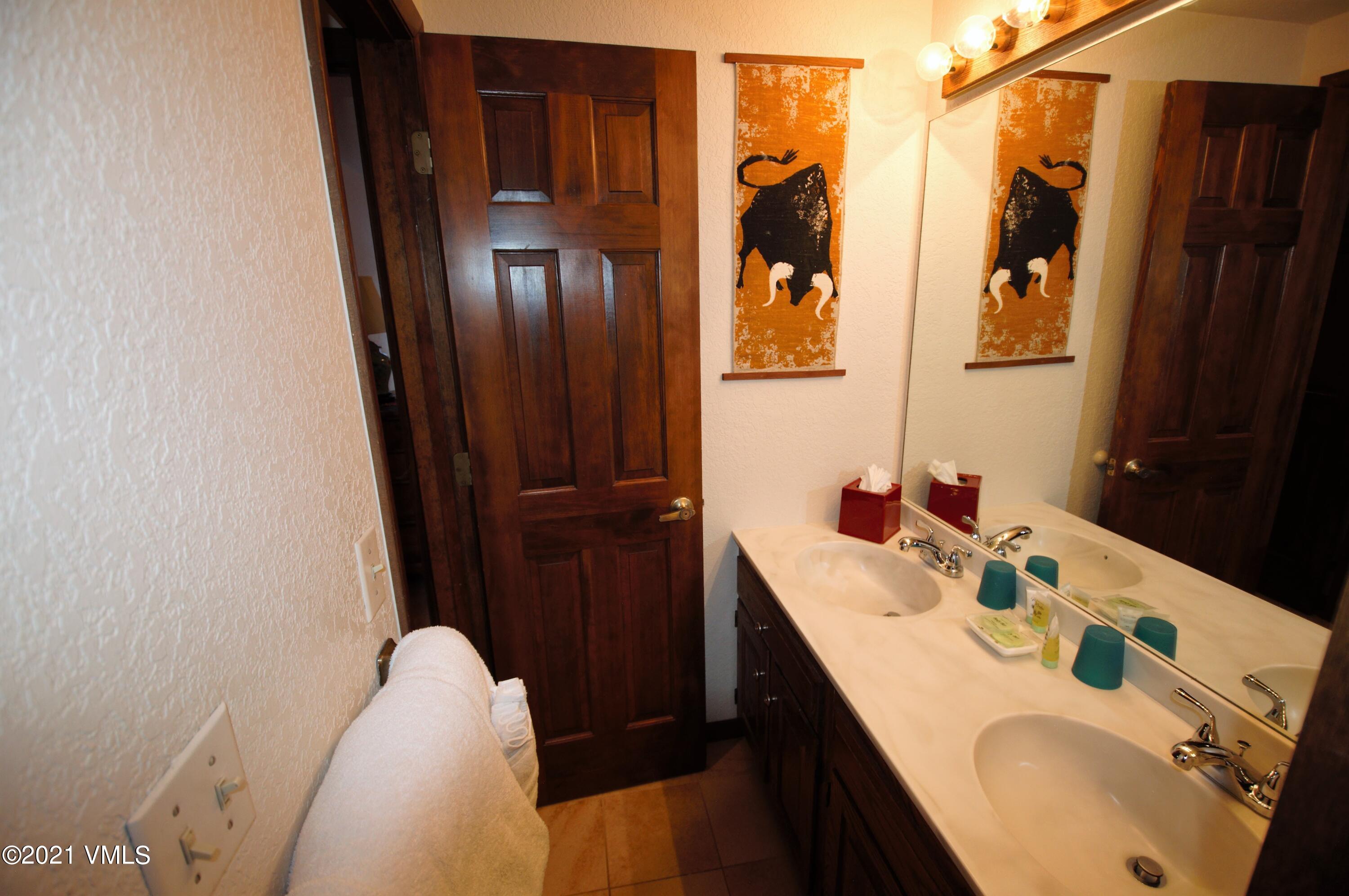 4484 Streamside Circle Vail, CO 81657 - Photo 15 of 29 a bathroom with a sink and a mirror
