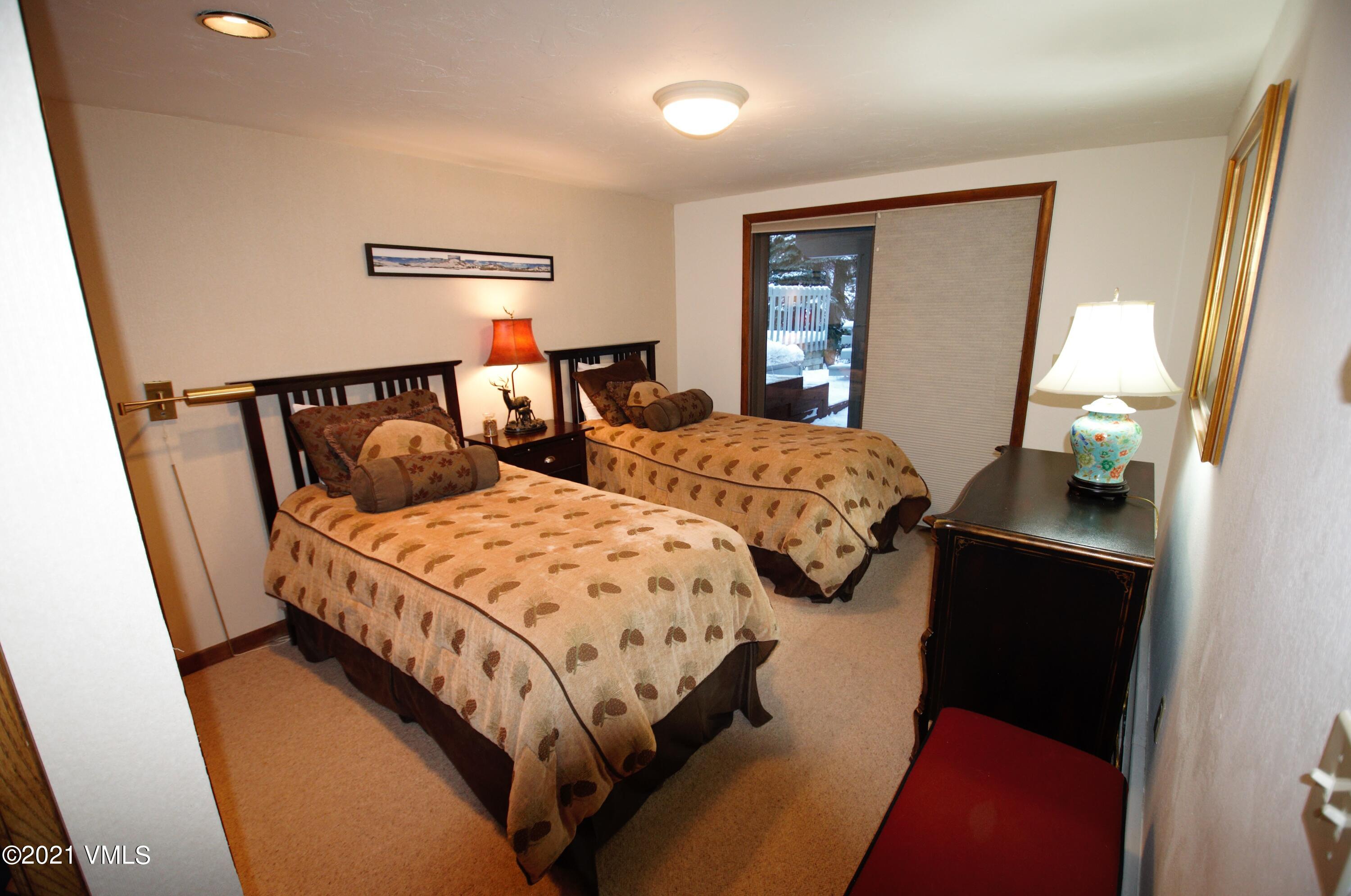 4484 Streamside Circle Vail, CO 81657 - Photo 16 of 29 a bedroom with two beds and painting on the wall