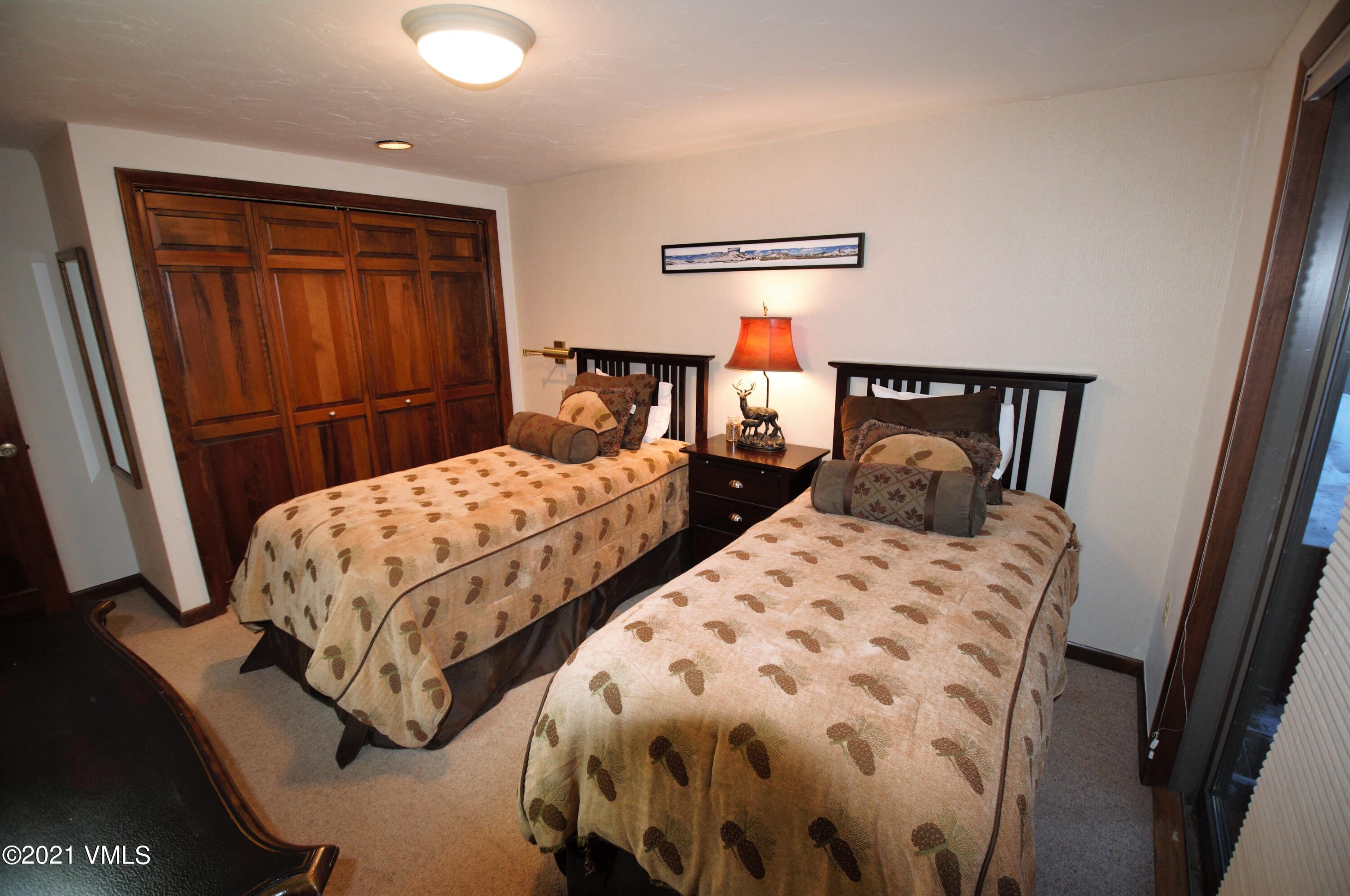 4484 Streamside Circle Vail, CO 81657 - Photo 17 of 29 a bedroom with two beds and painted walls