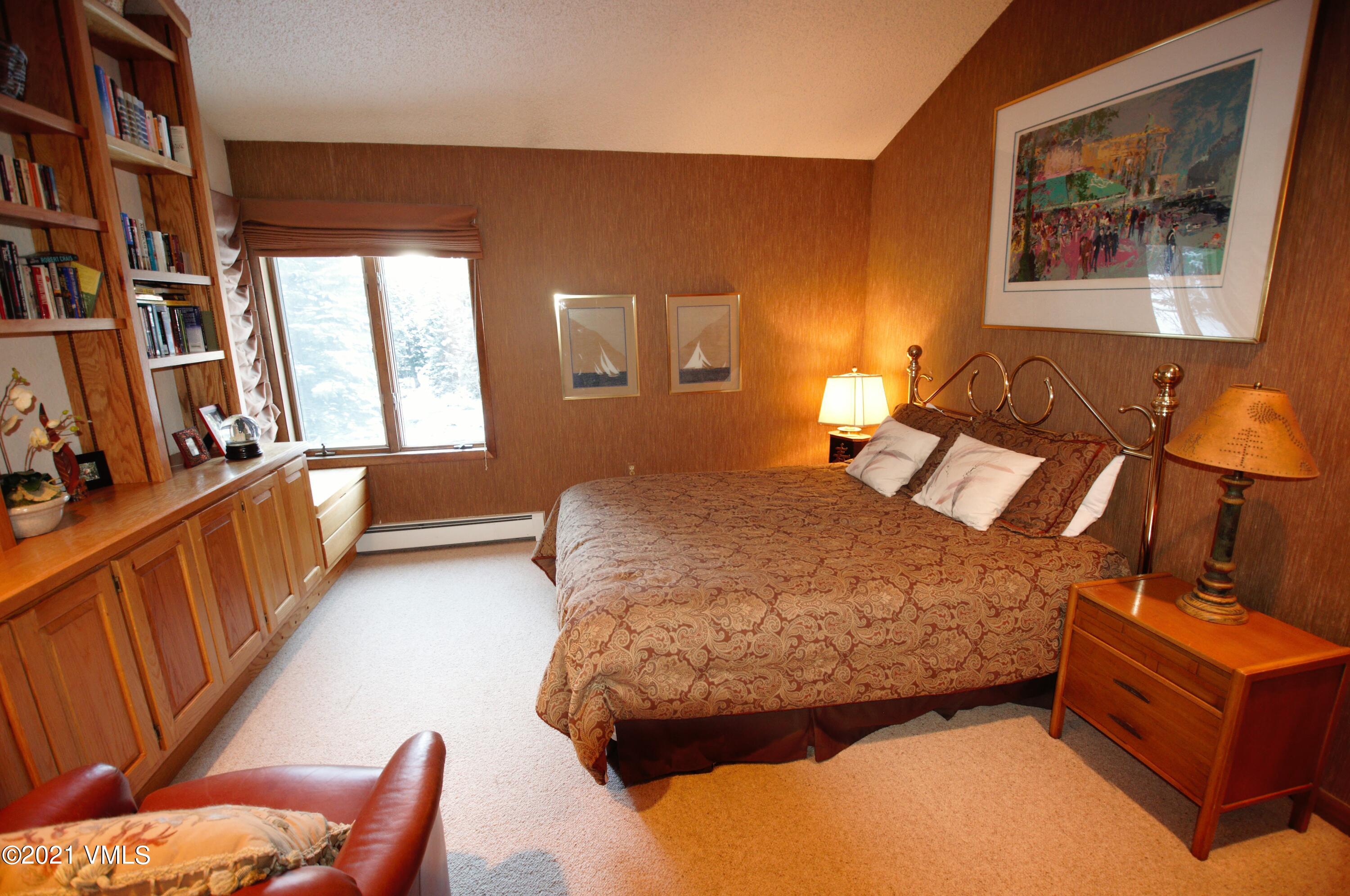4484 Streamside Circle Vail, CO 81657 - Photo 22 of 29 a bedroom with a bed and wooden floor
