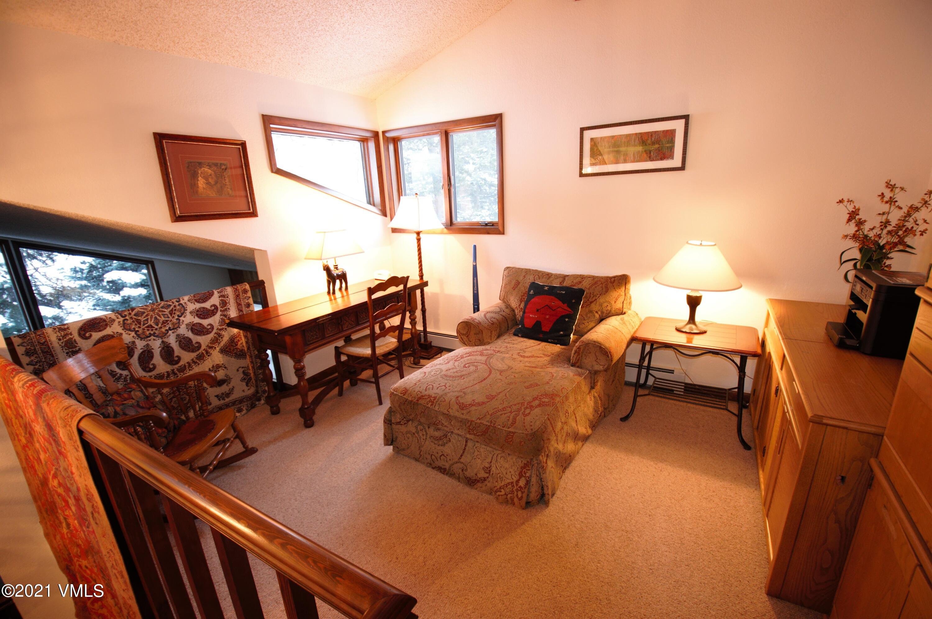 4484 Streamside Circle Vail, CO 81657 - Photo 23 of 29 a bedroom with furniture and a lamp