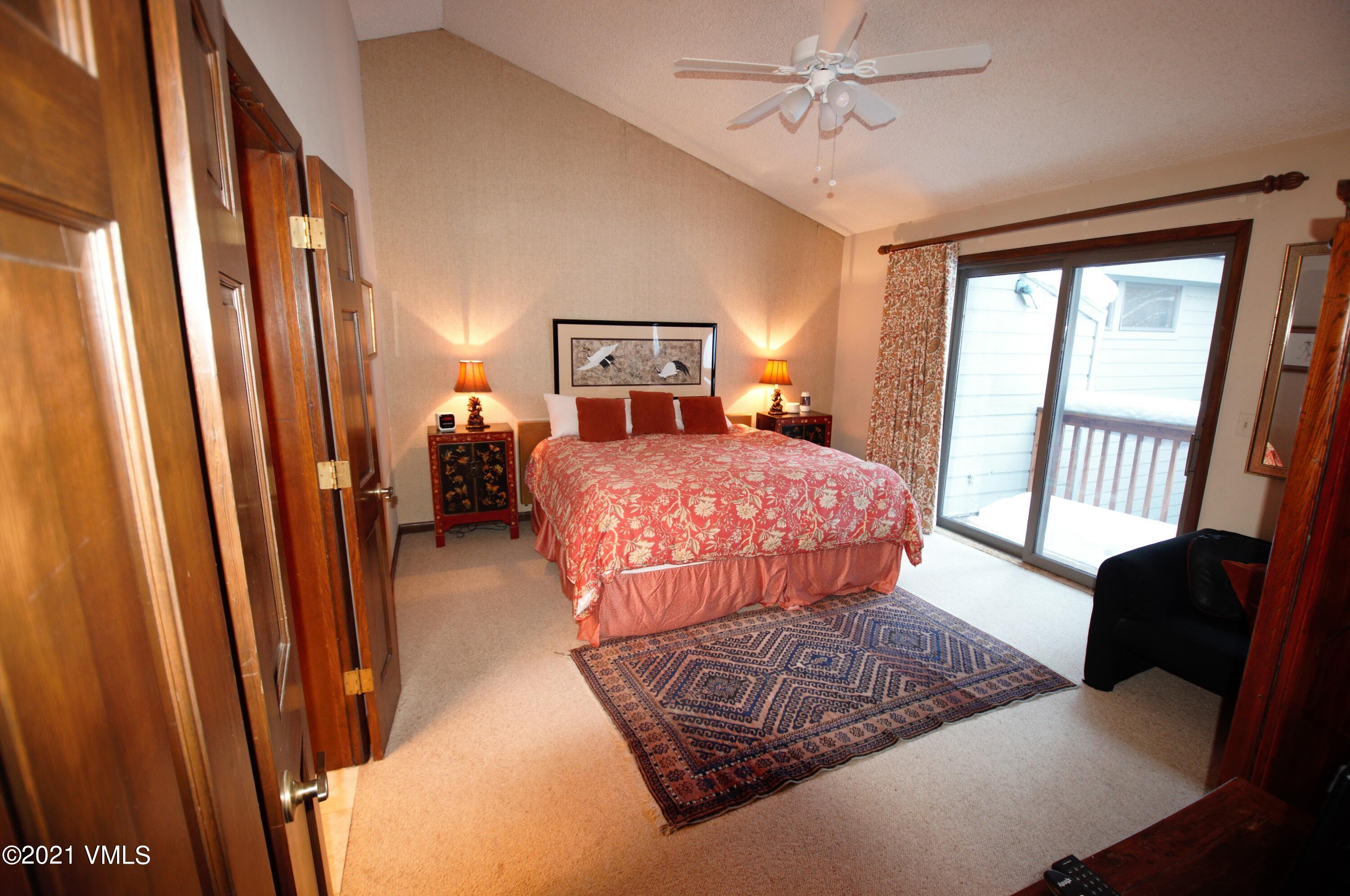 4484 Streamside Circle Vail, CO 81657 - Photo 24 of 29 a bedroom with a bed and wooden floor