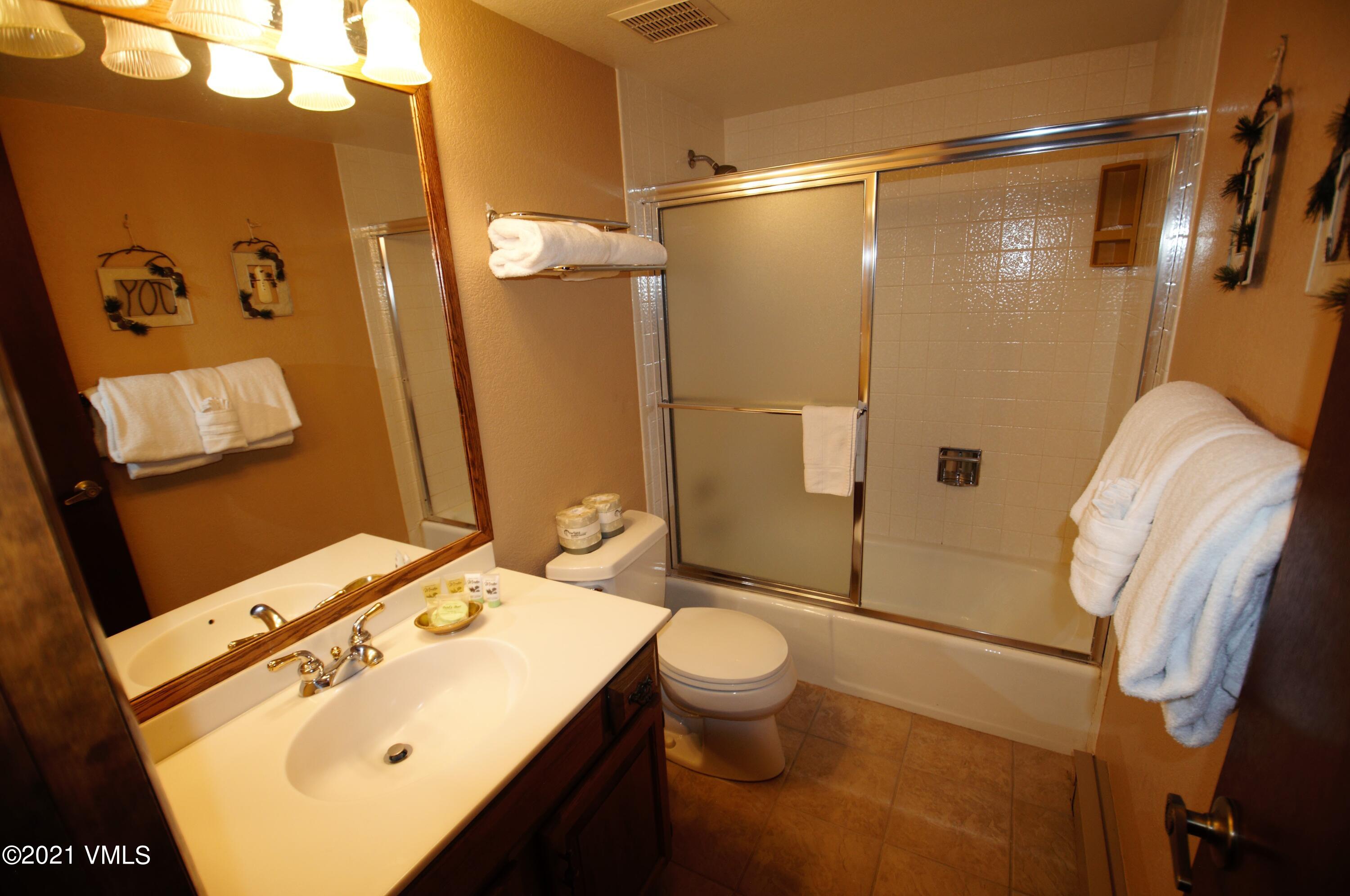 4484 Streamside Circle Vail, CO 81657 - Photo 28 of 29 a bathroom with a sink mirror vanity and toilet