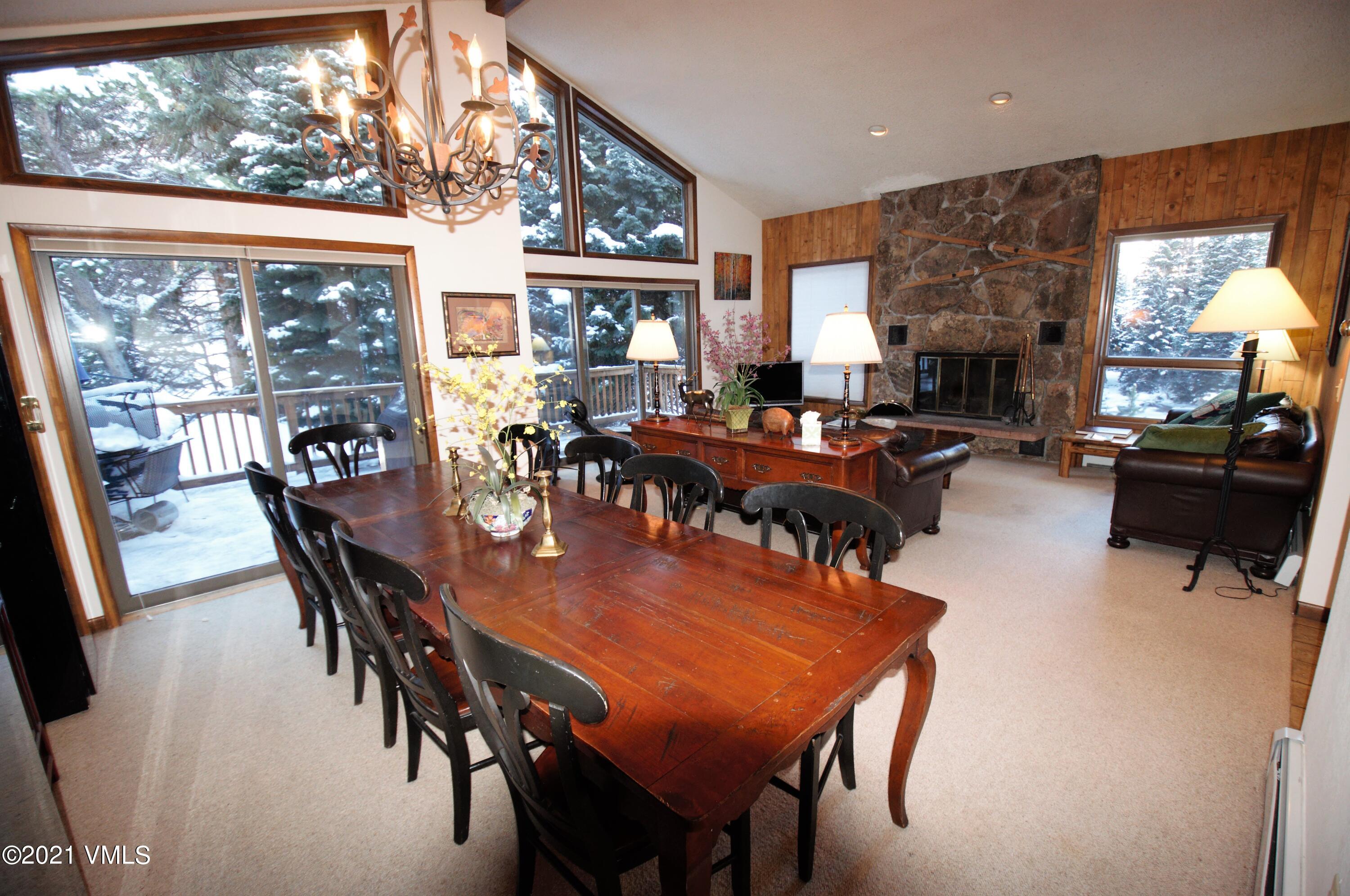 4484 Streamside Circle Vail, CO 81657 - Photo 5 of 29 a view of a dining room with furniture window and wooden floor