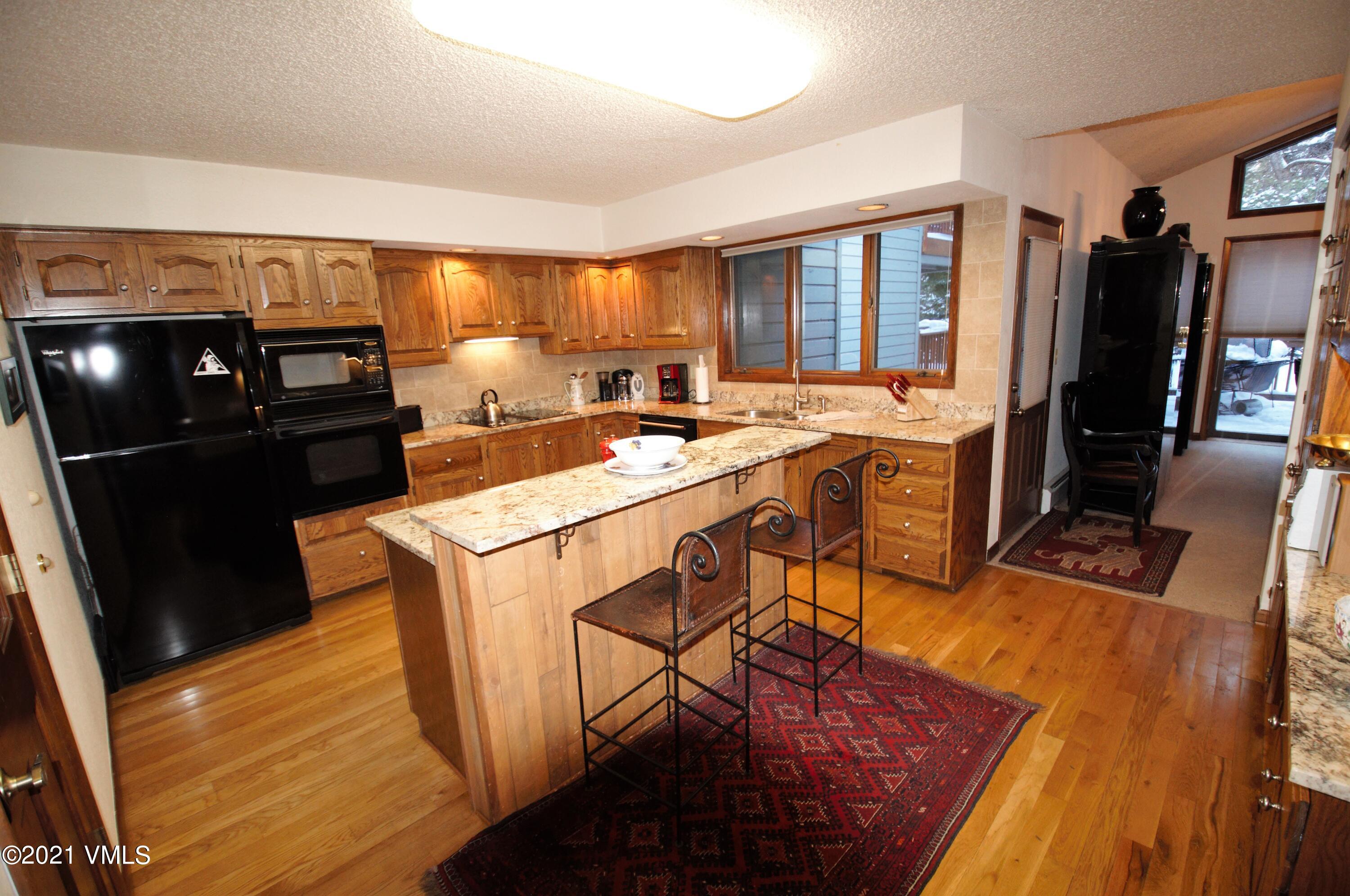 4484 Streamside Circle Vail, CO 81657 - Photo 6 of 29 a kitchen with a sink stove and refrigerator