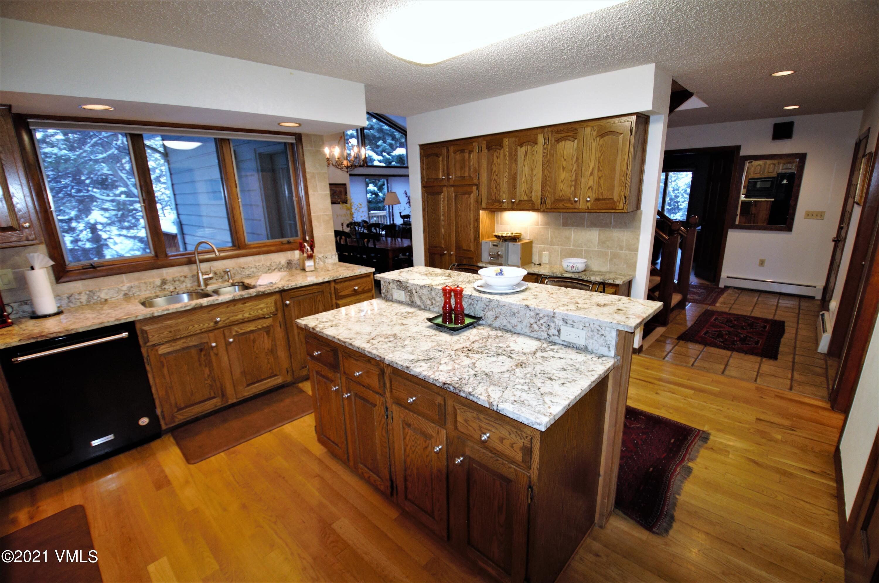4484 Streamside Circle Vail, CO 81657 - Photo 7 of 29 a kitchen with a stove a sink and a refrigerator