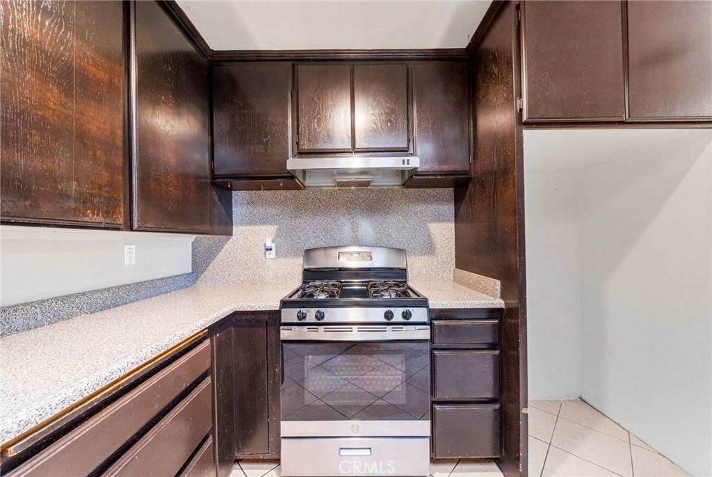 37310 Populus Avenue Palmdale, CA 93552 - Photo 11 of 28 a kitchen with granite countertop stainless steel appliances and wooden cabinets