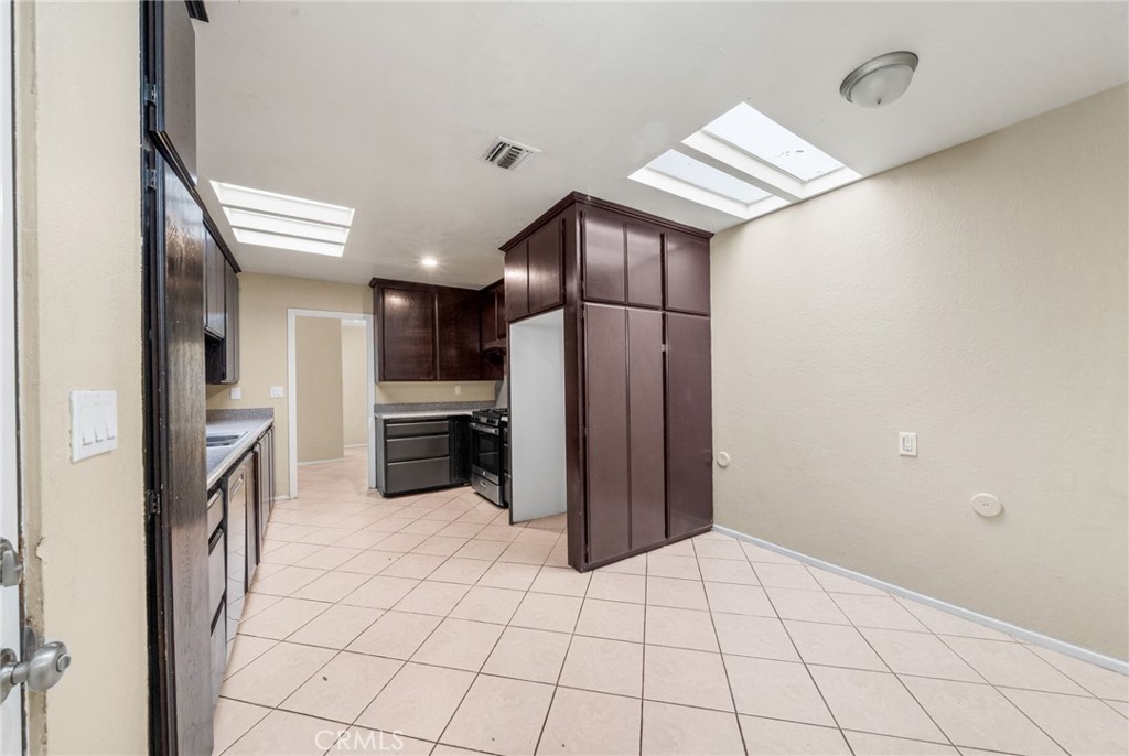 37310 Populus Avenue Palmdale, CA 93552 - Photo 12 of 28 a kitchen with a refrigerator and a sink
