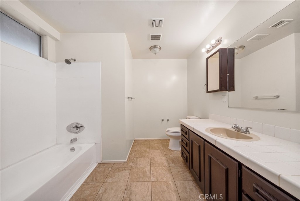 37310 Populus Avenue Palmdale, CA 93552 - Photo 18 of 28 a bathroom with a tub sink and mirror