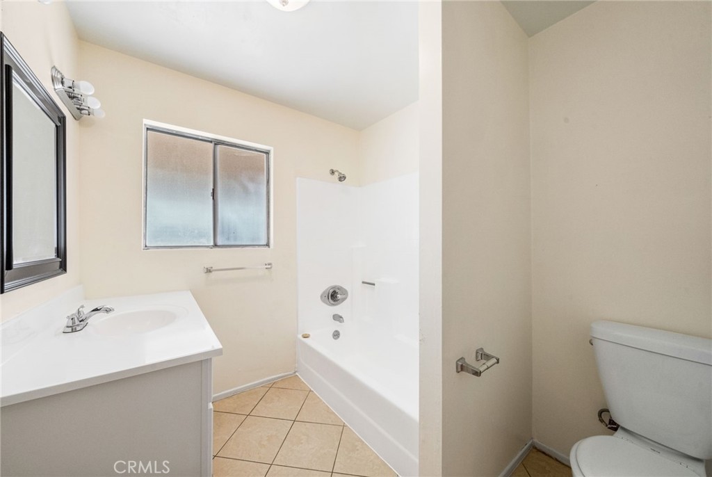 37310 Populus Avenue Palmdale, CA 93552 - Photo 23 of 28 a bathroom with a sink a toilet and shower