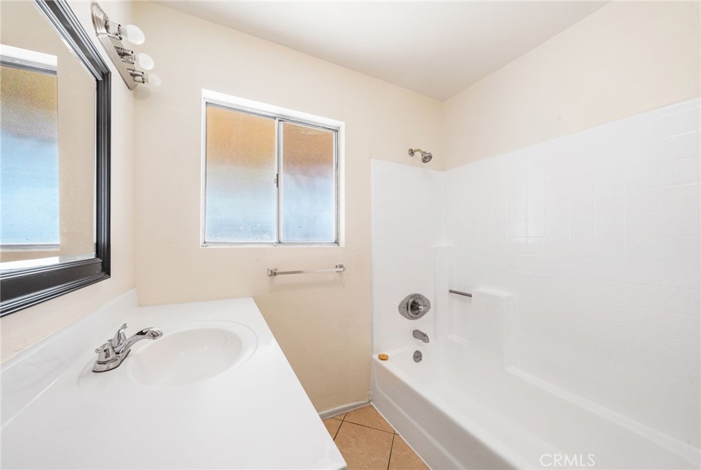 37310 Populus Avenue Palmdale, CA 93552 - Photo 24 of 28 a bathroom with a tub sink and mirror