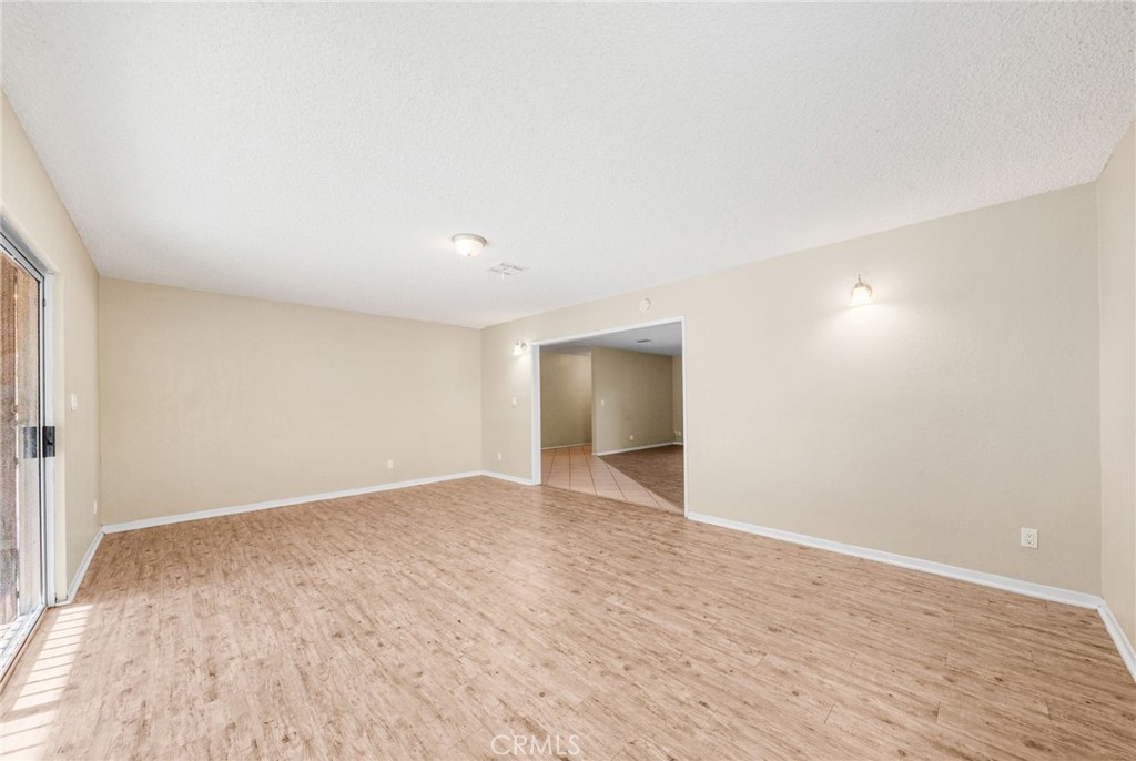 37310 Populus Avenue Palmdale, CA 93552 - Photo 8 of 28 a view of an empty room with wooden floor and a window