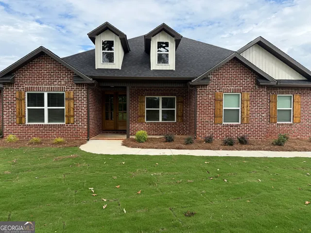 a view of empty room with wooden floor and fireplace