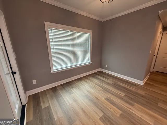 a view of an empty room and wooden floor