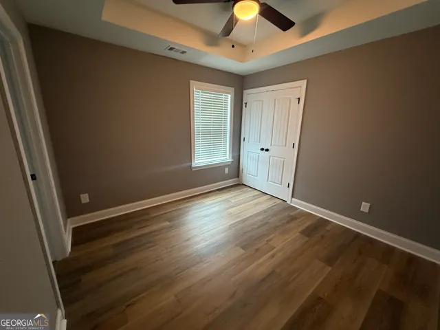 a bathroom with a glass shower door and a window