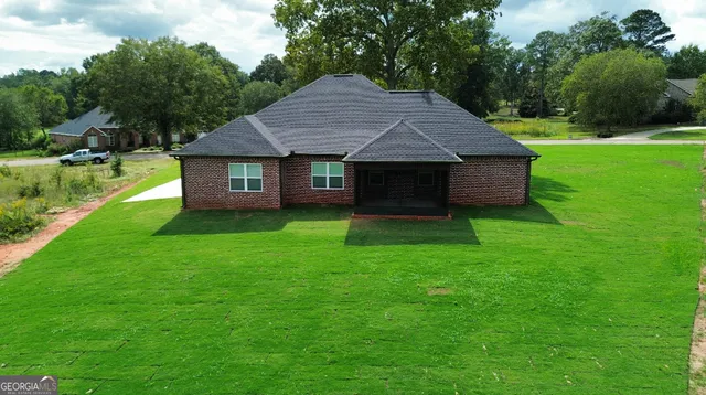 a front view of house with yard and green space