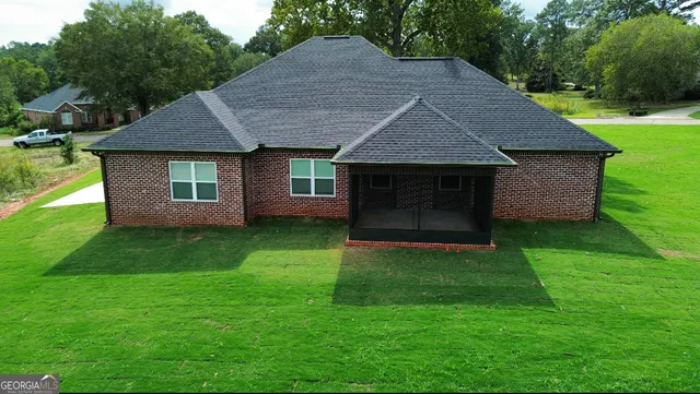 a view of a garden with a building in the background
