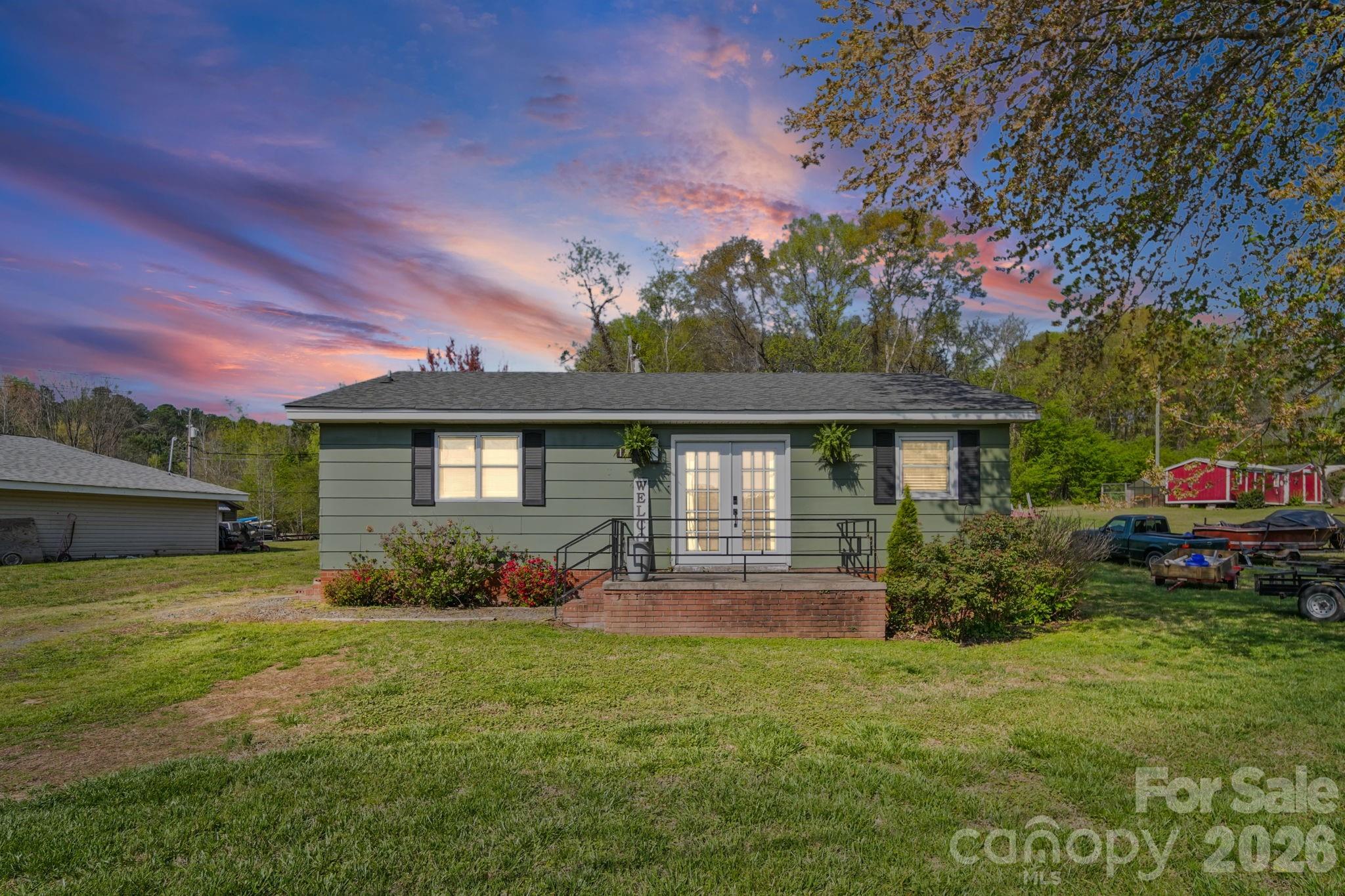 197 Vineyard Road Norwood, NC 28128 - Photo 1 of 27 a front view of a house with a yard and garage