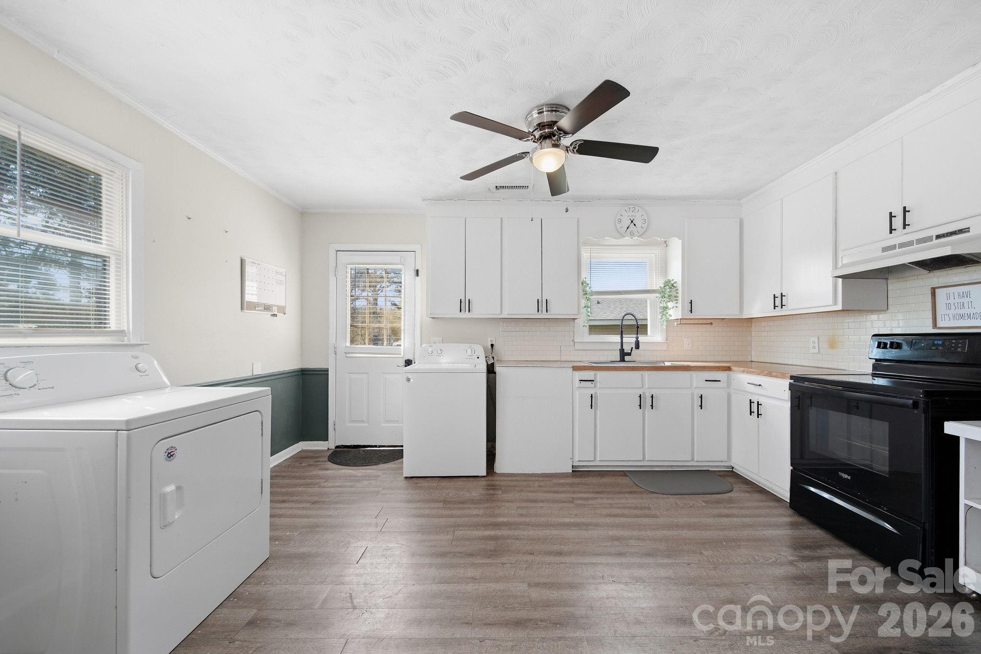 197 Vineyard Road Norwood, NC 28128 - Photo 13 of 27 a kitchen with white cabinets and appliances