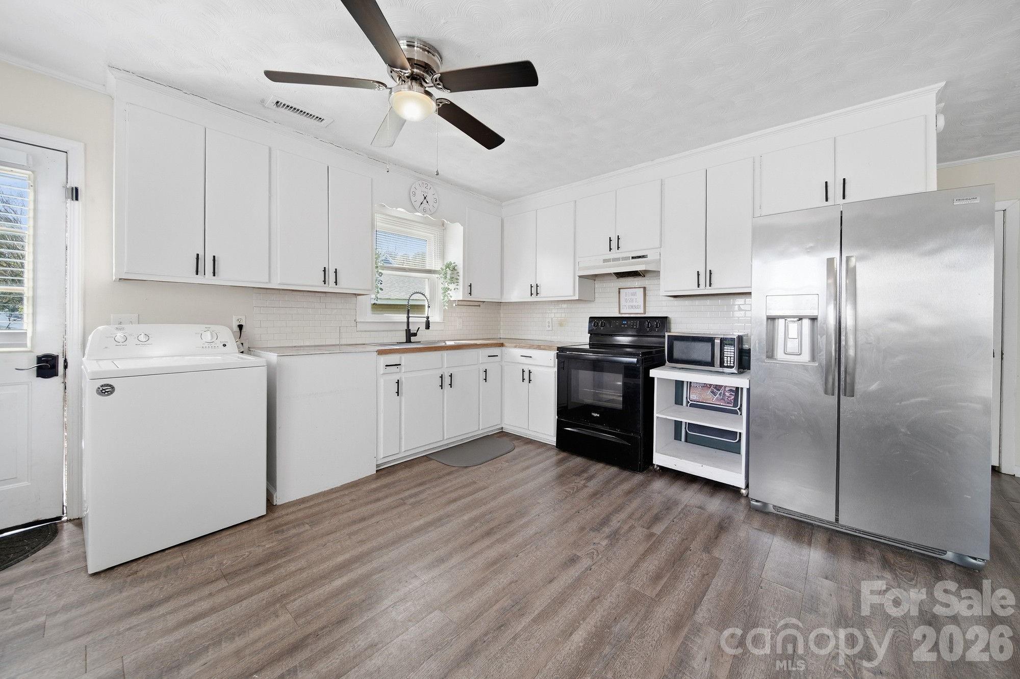 197 Vineyard Road Norwood, NC 28128 - Photo 14 of 27 a kitchen with cabinets stainless steel appliances and a window