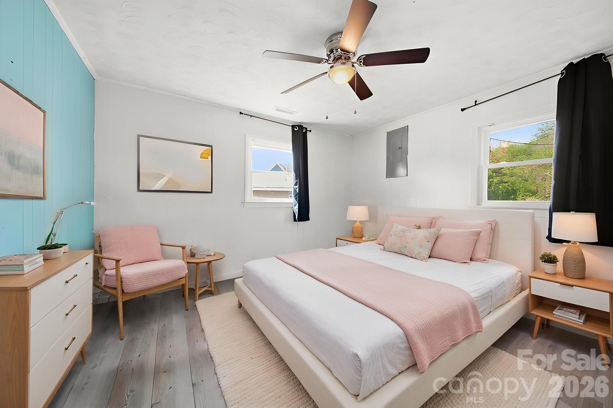 197 Vineyard Road Norwood, NC 28128 - Photo 17 of 27 a bedroom with a bed and a chandelier