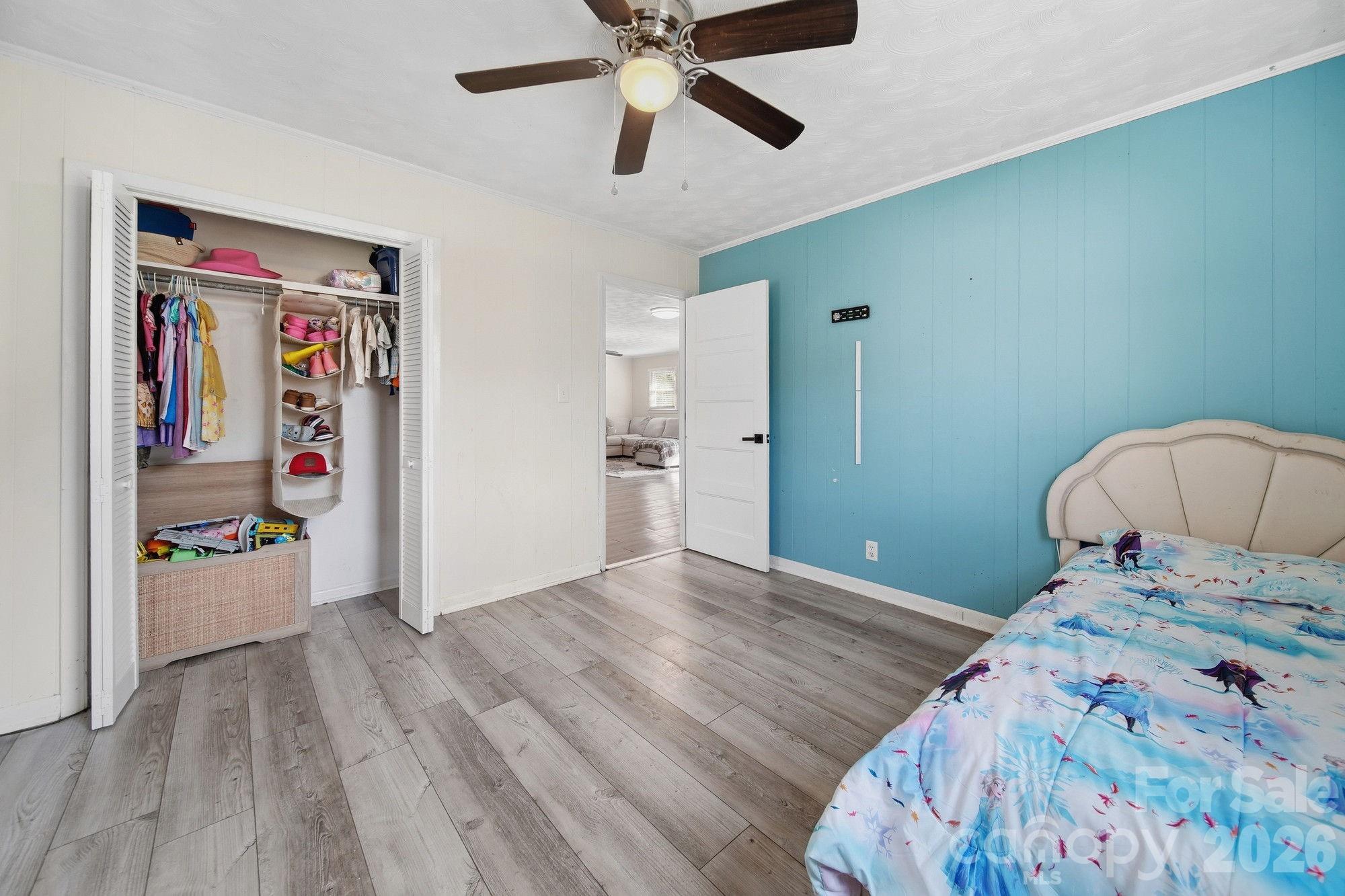 197 Vineyard Road Norwood, NC 28128 - Photo 21 of 27 a bedroom with a bed and wooden floor