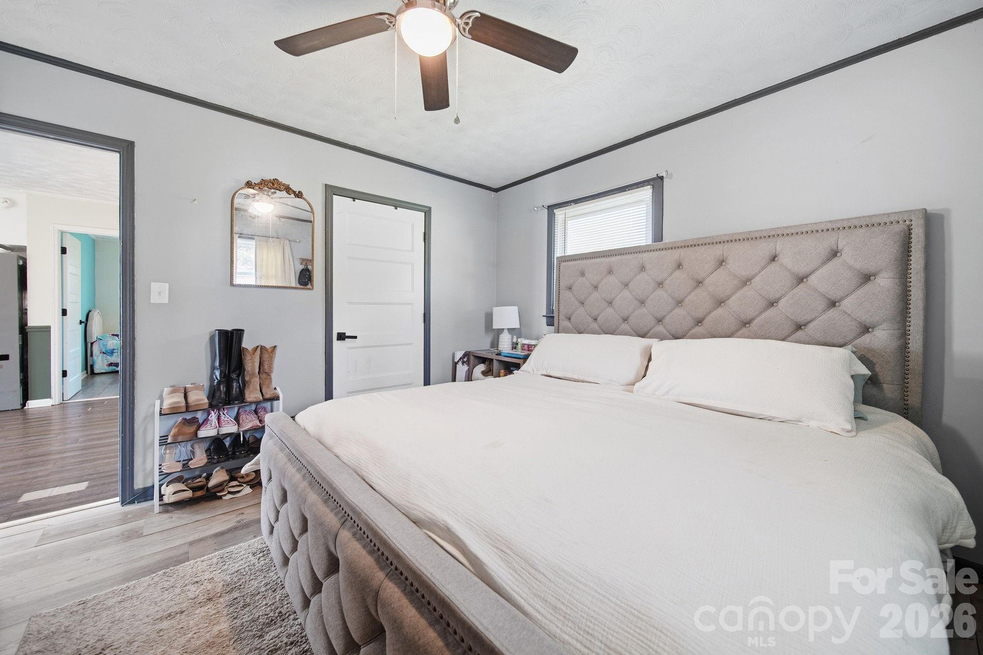 197 Vineyard Road Norwood, NC 28128 - Photo 22 of 27 a bed room with a bed and a chandelier