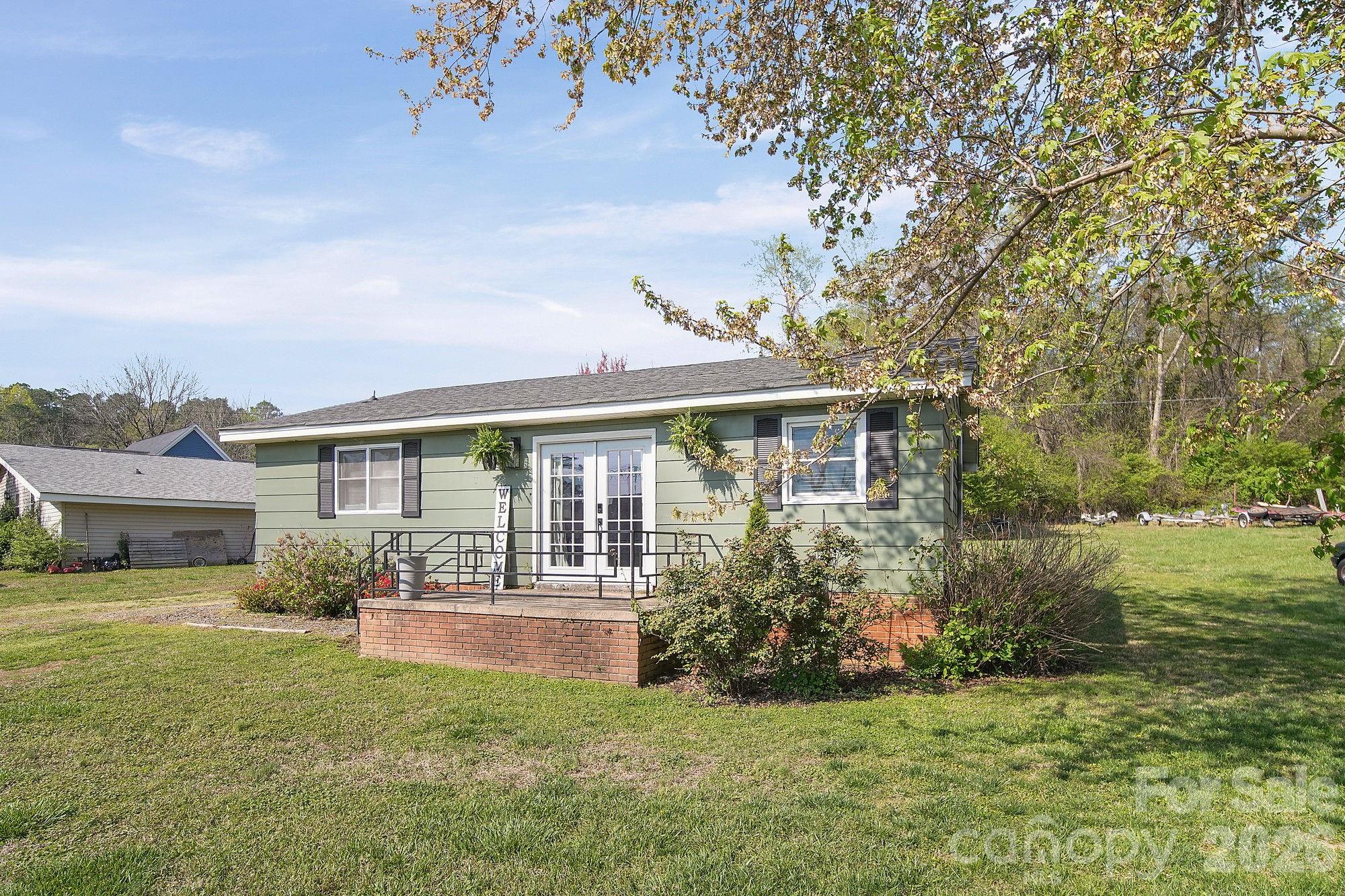 197 Vineyard Road Norwood, NC 28128 - Photo 3 of 27 a front view of a house with garden