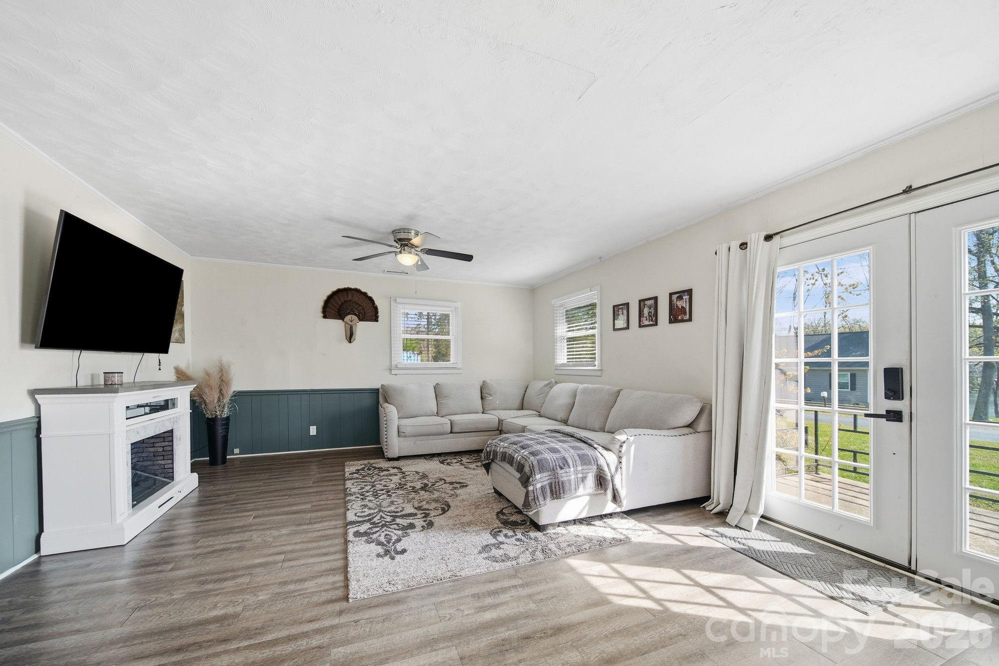 197 Vineyard Road Norwood, NC 28128 - Photo 5 of 27 a living room with furniture and a flat screen tv