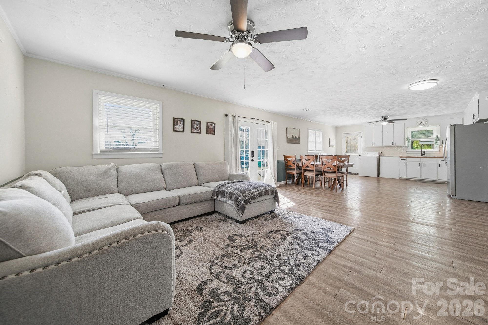 197 Vineyard Road Norwood, NC 28128 - Photo 7 of 27 a living room with furniture or wooden floor and a ceiling fan